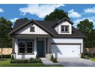 Charming new construction home featuring a gray roof, siding, and a two-car garage at 1035 Bourn Ln, Waxhaw, NC 28173