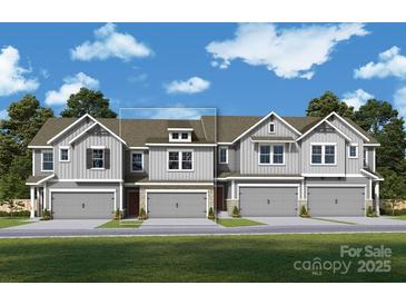 New townhouse row featuring 2-car garages and craftsman-style architectural details at 113 Alluvium Ln, Waxhaw, NC 28173