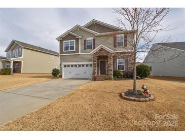 Charming two-story home with stone accents, well-manicured lawn, and two car garage at 173 Glastonbury Dr, Mooresville, NC 28115