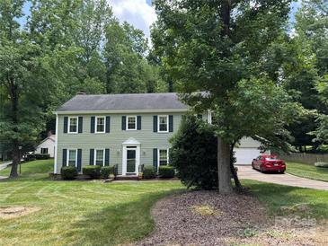 Charming two-story home with green siding, dark shutters, and well-manicured lawn at 1919 Windlock Dr, Charlotte, NC 28270
