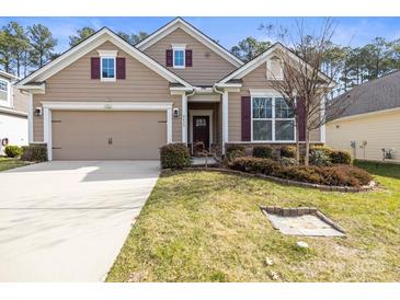 Charming home featuring a two-car garage, manicured lawn, and warm, inviting curb appeal at 2479 Seagull Dr, Denver, NC 28037