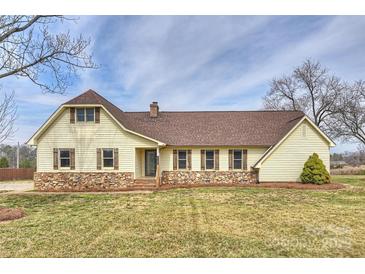 Charming one-story home with stone accents, brown shutters, and a well-manicured lawn at 332 Goforth Rd, Kings Mountain, NC 28086