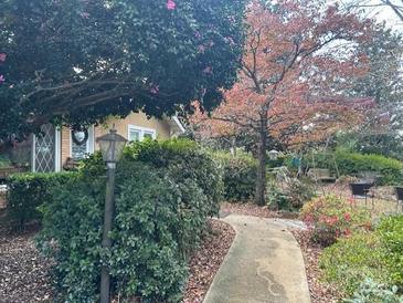 Charming home with a beautiful front yard, lush greenery, and a winding walkway at 33320-B Hobe Rd, Albemarle, NC 28001