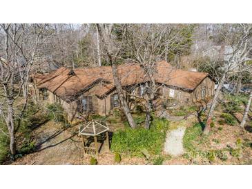 Traditional brick home featuring a well maintained yard, brown shutters, and a quaint gazebo at 5515 Birchhill Rd, Mint Hill, NC 28227