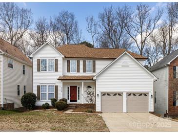 Charming two-story home featuring a well-manicured lawn, a two-car garage and a classic front door at 6529 Harburn Forest Dr, Charlotte, NC 28269