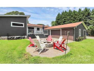 Cozy backyard fire pit area with seating, perfect for outdoor entertaining at 9808 Washam Potts Rd, Cornelius, NC 28031