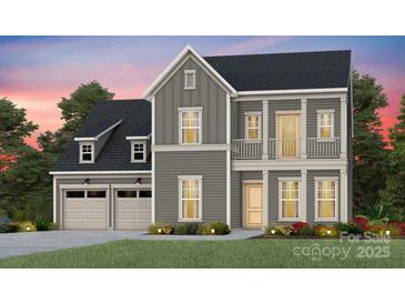 Charming two-story home with a welcoming front porch, attached two-car garage, and landscaped yard at 1049 Kinship Dr # 77, Lancaster, SC 29720