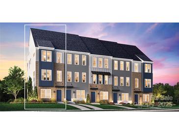 Beautiful new townhomes feature brick accents, multiple windows, and professionally landscaped lawns at 2035 Clarksdale Dr # 33, Charlotte, NC 28206