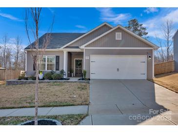 Charming one-story home with well-maintained landscaping, a two car garage, and lovely curb appeal at 2324 Lanza Dr, Charlotte, NC 28215