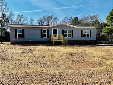 Charming single-story home featuring vinyl siding, black shutters, and a cozy front porch with wood stairs at 280 Fairchase Cir # 59, Stony Point, NC 28678