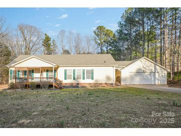 Charming single-story home with a welcoming front porch and a detached two-car garage at 2864 Sweeping Pine Ln, Denver, NC 28037