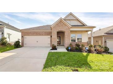 Charming single-Gathering home showcasing a manicured lawn, brick accents, and an attached two-car garage at 3532 Tully Ave, Kannapolis, NC 28081