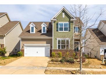 Inviting two-story home featuring a well-manicured lawn, attached garage, and charming architectural details at 844 Braddock Way, Fort Mill, SC 29715
