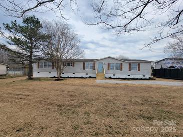 Charming single-story home with a well-maintained lawn and inviting front entrance at 1170 Meadowcreek Dr, China Grove, NC 28023