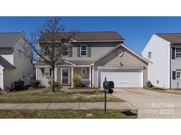 Charming two-story home featuring a well-manicured lawn and inviting front porch at 12915 Deaton Hill Dr, Charlotte, NC 28269