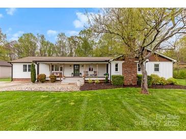 Charming ranch-style home with a cozy front porch and well-manicured lawn at 1335 Blacksnake Rd, Stanley, NC 28164