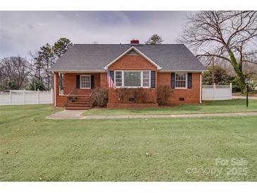 Charming brick home featuring a well-manicured lawn and classic architectural details, creating an inviting curb appeal at 204 Julia Ave, Belmont, NC 28012