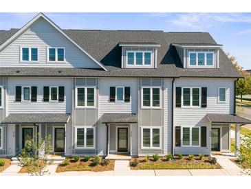Charming townhome with classic architectural details and a well-maintained facade in a desirable neighborhood at 210 Freeland Ln, Charlotte, NC 28217