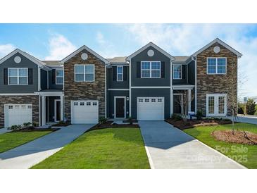 Charming townhomes feature stone accents, individual garages, and well-manicured lawns at 3160 Ora Smith Rd, Lincolnton, NC 28092