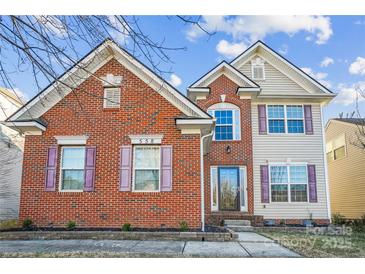 Charming brick and vinyl two-story home with colorful shutters and well-maintained landscaping at 558 Rough Hewn Ln, Rock Hill, SC 29730