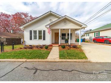 Charming single-story home featuring a welcoming front porch and well-maintained landscaping at 719 Washington St, Cramerton, NC 28032