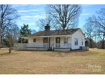 Charming single-story home featuring a welcoming front porch and a well-maintained yard at 7311 Dogwood Ln, Kannapolis, NC 28081