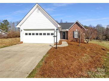 Charming single-story home with brick and white siding and an attached garage at 807 Limerick Dr, Dallas, NC 28034