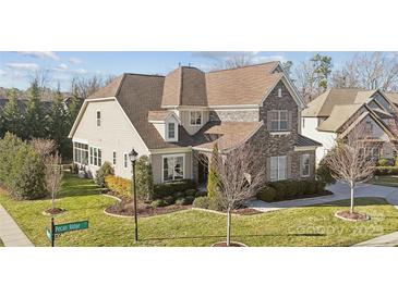 Beautiful home featuring a combination of stone and siding, complemented by manicured landscaping at 401 Pecan Ridge Ct, Weddington, NC 28104