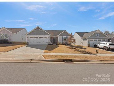 Charming single-story home with a two-car garage, well-maintained lawn, and inviting curb appeal at 609 Grandiflora Ave, Lancaster, SC 29720
