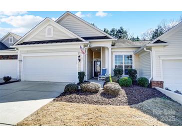 Charming single-story home featuring a well-manicured lawn, front porch, and attached two-car garage at 9005 Smokey Hill Ln, Indian Land, SC 29707