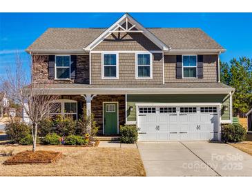 Charming two-story home with stone and shingle siding, attached two-car garage, and well-manicured front lawn at 10379 Black Locust Ln, Charlotte, NC 28215