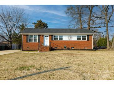 Charming brick home with a well-maintained lawn and a welcoming front entrance at 1597 Mcgill St, Rock Hill, SC 29732