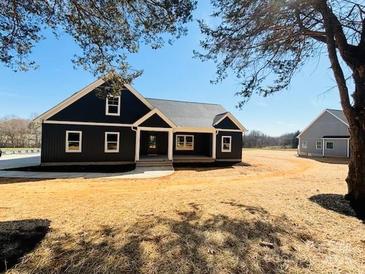 Charming home with a striking black exterior and a well-manicured front yard on a sunny day at 169 Lone Pine Rd, Statesville, NC 28625