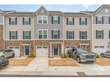 Charming townhome with stone accents, two-car garage, and inviting curb appeal at 2311 Doby Creek Ln, Charlotte, NC 28262
