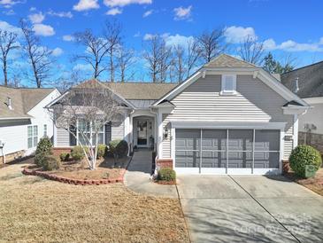 Charming single-story home featuring neutral siding, well-maintained landscaping and an attached two car garage at 52194 Longspur Ln, Fort Mill, SC 29707