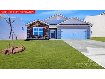 Charming single-story home featuring a manicured lawn and a classic two-car garage at 5235 Reedy Ridge Rd, Charlotte, NC 28215
