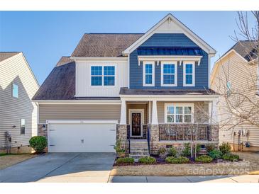 Charming two-story home featuring a mix of siding, stone accents, manicured landscaping, and a two-car garage at 646 Kahana River Rd, Fort Mill, SC 29715