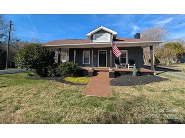Charming home featuring inviting front porch, walkway, and beautiful landscaping at 101 Sunset Dr, Stanley, NC 28164