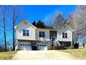 Charming two-story home featuring white siding, stone accents, and a two-car garage at 1609 Indian Springs Nw Dr # 35, Conover, NC 28613