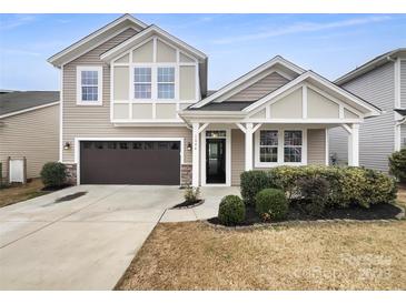 Charming two-story home showcasing a well-maintained yard, covered front porch, and attached garage at 1844 Burlington Dr, York, SC 29745