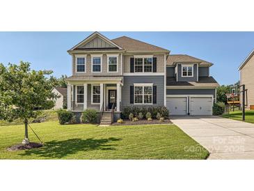 Charming two-story home with a well-manicured lawn and a two-car garage at 274 Sweet Briar Dr, Fort Mill, SC 29707