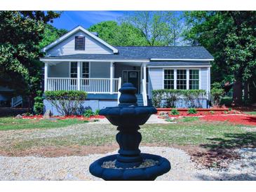 Charming home featuring a lovely front porch, tidy landscaping, and a decorative fountain at 315 Confederate St, Fort Mill, SC 29715