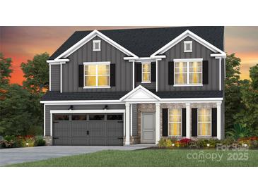 Charming two-story home featuring gray siding, black shutters, and a well-manicured lawn at 3832 Pee Dee St # 41, Monroe, NC 28110
