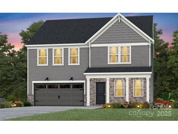 Charming two-story home with a combination of stone and siding, complemented by a well-manicured lawn at 3844 Pee Dee St # 43, Monroe, NC 28110