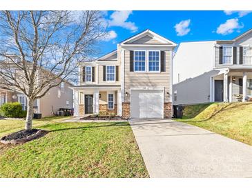 Traditional home with a well-maintained lawn and a two-car garage at 4115 Kellybrook Dr, Concord, NC 28025