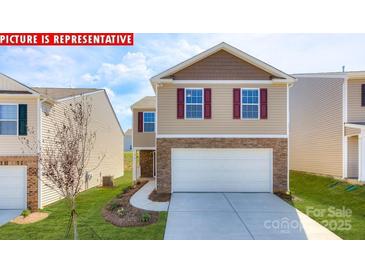 Charming two-story home with stone accents, a two-car garage, and a well-manicured lawn at 11225 Cardinal Creek Ave, Charlotte, NC 28215