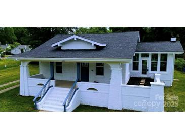 Charming bungalow with a freshly painted white brick exterior and inviting front porch at 113 Brawley St, Chester, SC 29706