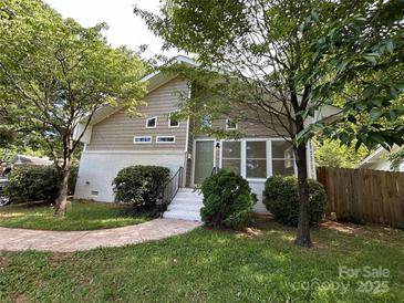 Charming two-story home with brick accents and a welcoming front entrance and mature landscaping at 1713 Archdale Dr, Charlotte, NC 28210