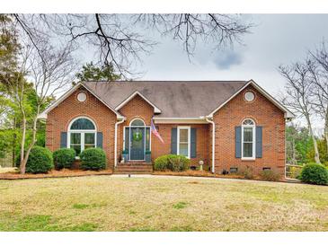 Charming brick home with a well-maintained front yard, a beautiful entry door, and mature landscaping at 2745 Bonnybrook Cir, Rock Hill, SC 29732
