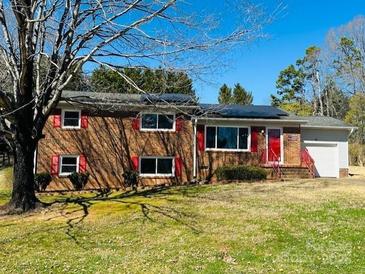 Charming brick home featuring a vibrant red door and shutters, enhancing its curb appeal at 344 Circleview Dr, Shelby, NC 28150